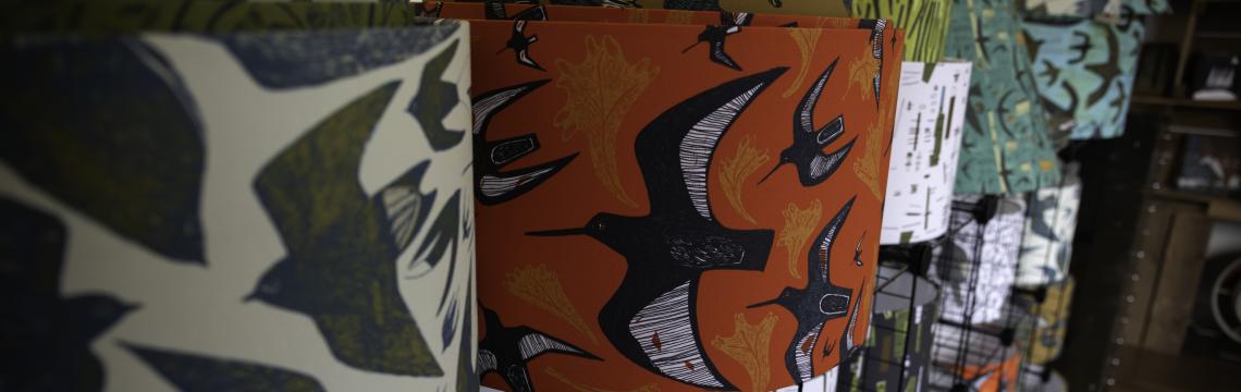 Lampshades on shelves in shop